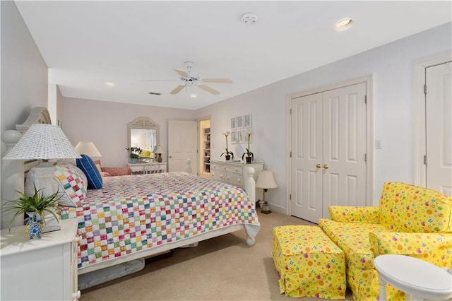 bedroom featuring light colored carpet, a closet, a ceiling fan, and recessed lighting