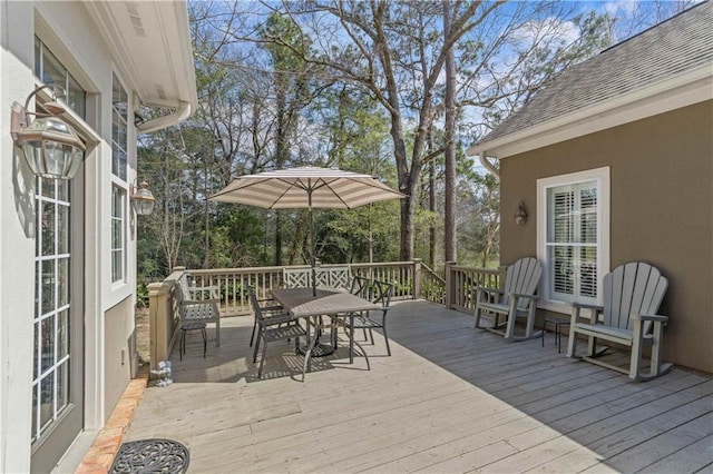 wooden terrace featuring outdoor dining area