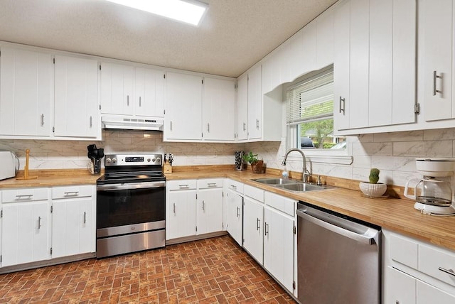 2808 Westmoor Ct, Mobile, AL 36695 - kitchen featuring appliances with stainless steel finishes, a sink, under cabinet range hood, brick patterned flooring, and decorative backsplash
