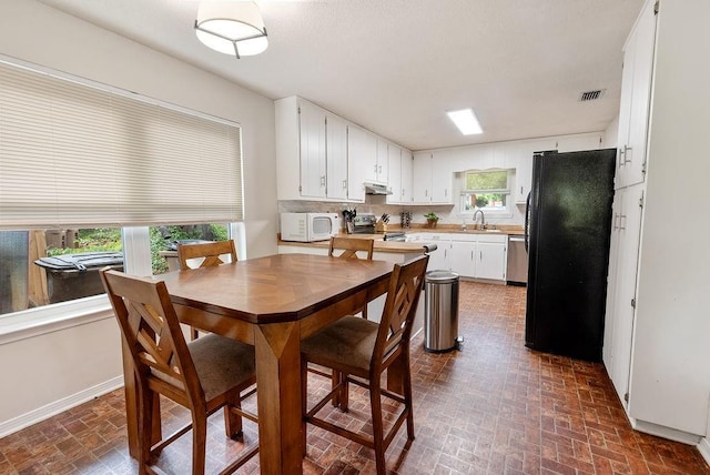 2808 Westmoor Ct, Mobile, AL 36695 - dining area featuring brick patterned flooring and baseboards