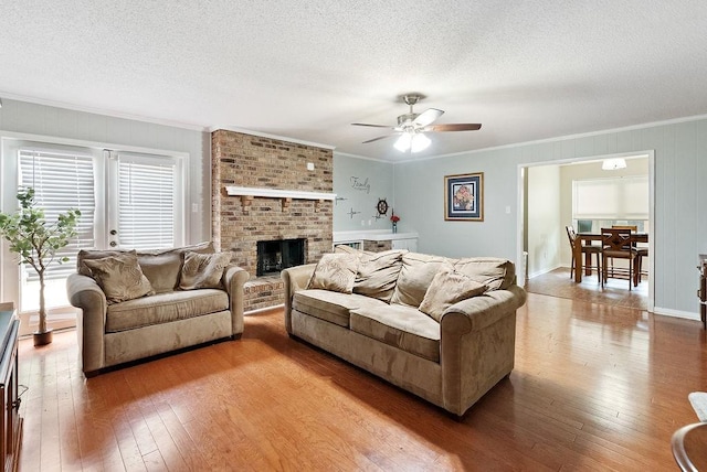 2808 Westmoor Ct, Mobile, AL 36695 - living area with ornamental molding, hardwood / wood-style flooring, ceiling fan, a textured ceiling, and a brick fireplace
