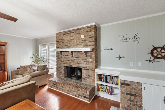 2808 Westmoor Ct, Mobile, AL 36695 - living area with a brick fireplace, wood finished floors, crown molding, a textured ceiling, and wooden walls