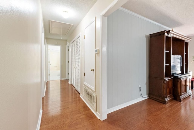 2808 Westmoor Ct, Mobile, AL 36695 - hall with attic access, a textured ceiling, wood finished floors, baseboards, and crown molding
