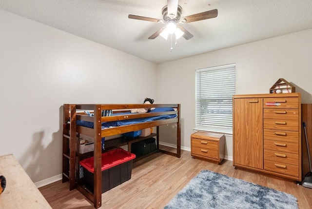 2808 Westmoor Ct, Mobile, AL 36695 - bedroom featuring light wood finished floors, baseboards, ceiling fan, and a textured ceiling