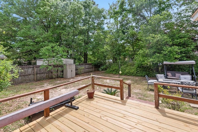 2808 Westmoor Ct, Mobile, AL 36695 - wooden terrace with a fenced backyard, an outdoor hangout area, and an outbuilding