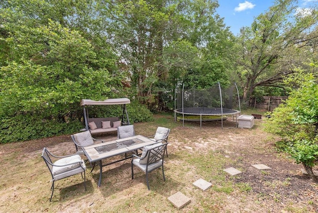 2808 Westmoor Ct, Mobile, AL 36695 - view of yard featuring a trampoline, fence, and outdoor lounge area