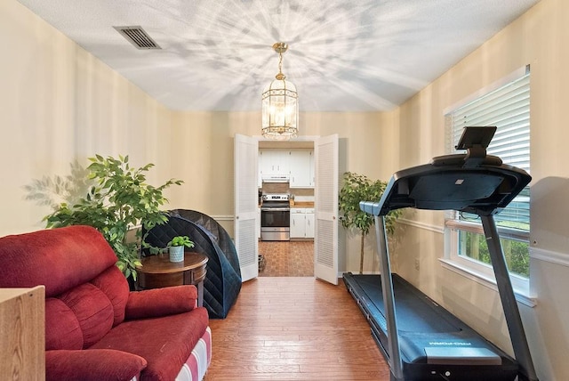 2808 Westmoor Ct, Mobile, AL 36695 - exercise area with wood-type flooring and a chandelier