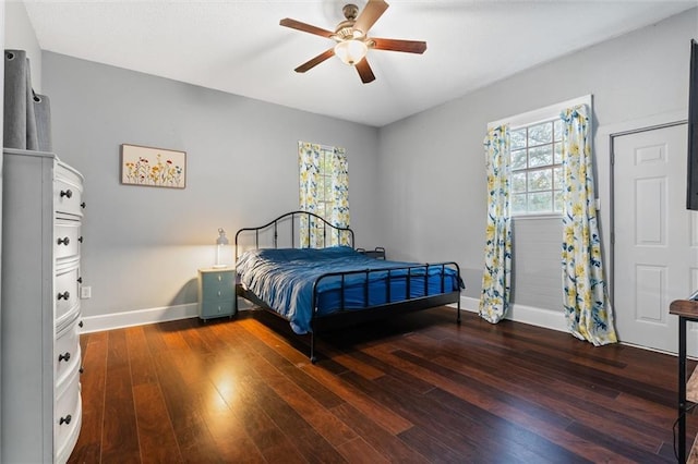 bedroom with baseboards, wood-type flooring, and ceiling fan