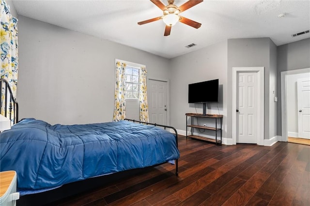 bedroom featuring visible vents, a ceiling fan, baseboards, and wood finished floors