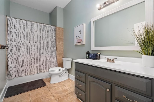 bathroom with tile patterned floors, shower / bath combo with shower curtain, toilet, baseboards, and vanity