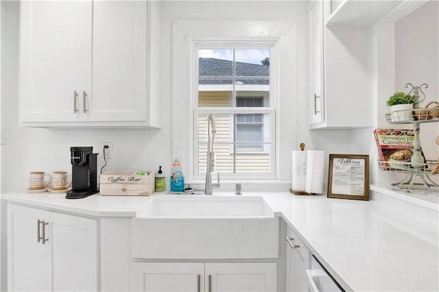 kitchen featuring white cabinets and sink