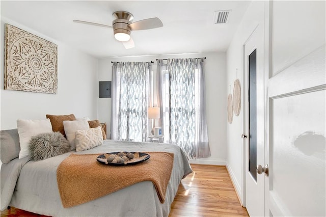 bedroom with ceiling fan and light wood-type flooring