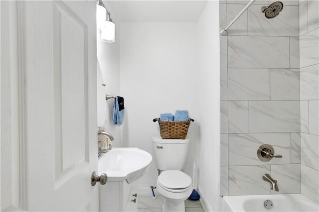 full bathroom with tiled shower / bath, vanity, and toilet