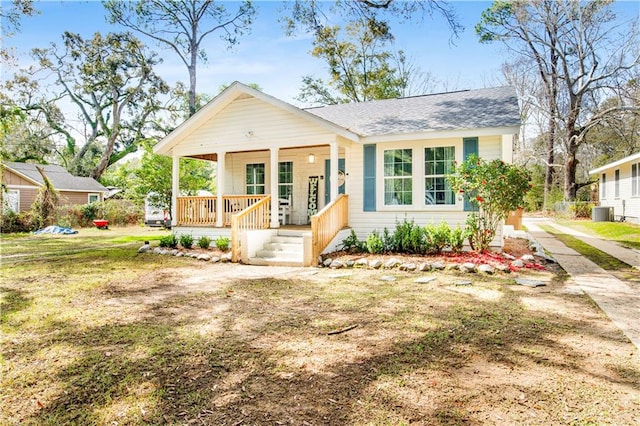 view of front of home featuring a front lawn, central AC, and covered porch