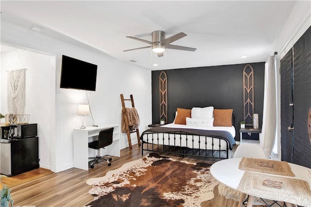 bedroom featuring hardwood / wood-style floors and ceiling fan