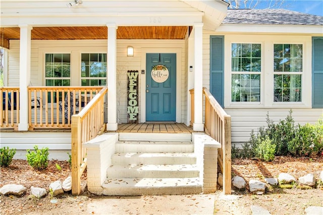 view of exterior entry with a porch