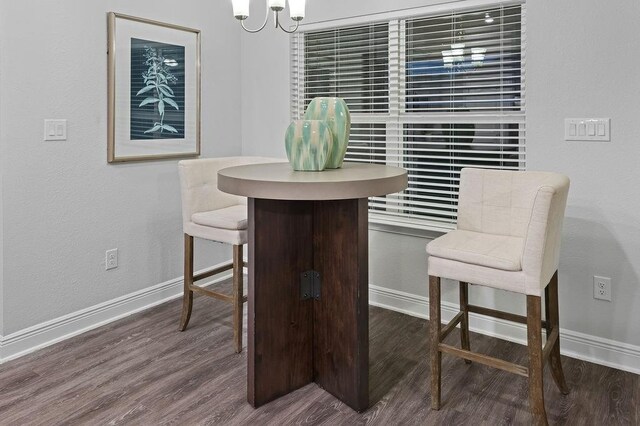 dining space featuring baseboards and wood finished floors