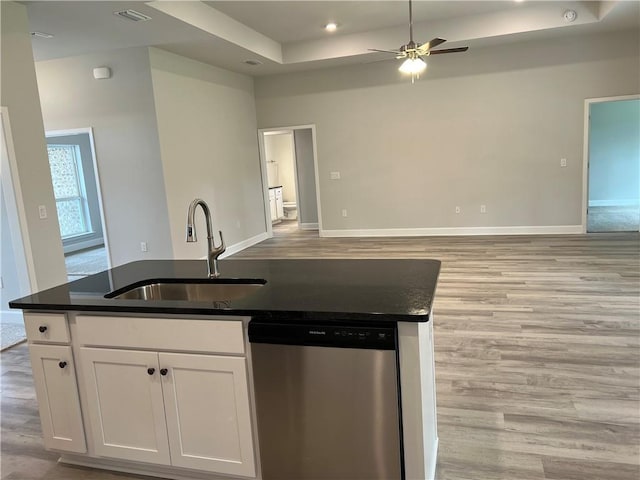 kitchen with visible vents, light wood finished floors, a sink, dishwasher, and open floor plan