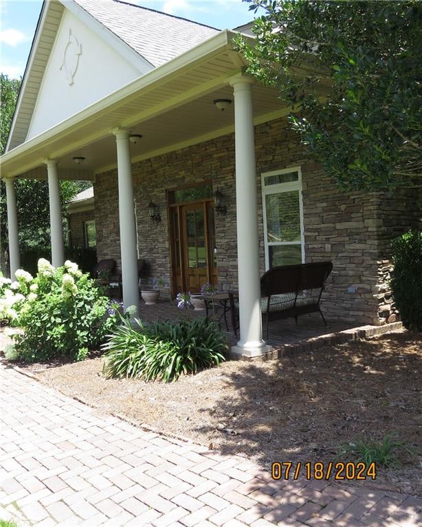 doorway to property with covered porch