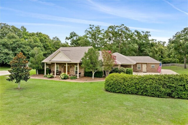 view of front of home featuring brick siding, covered porch, and a front yard