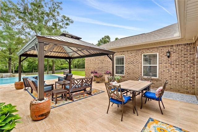 view of patio / terrace featuring a gazebo, outdoor dining area, and an outdoor pool