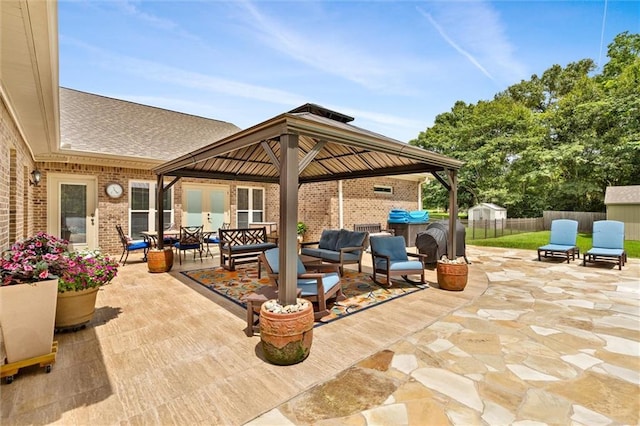 view of patio / terrace with a gazebo, fence, and an outdoor hangout area