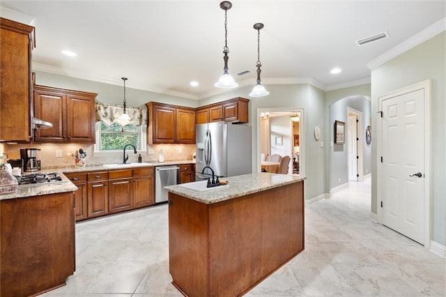 kitchen with tasteful backsplash, a center island, stainless steel appliances, arched walkways, and hanging light fixtures