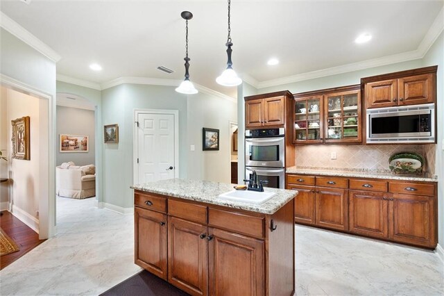 kitchen with light tile patterned flooring, appliances with stainless steel finishes, crown molding, and backsplash