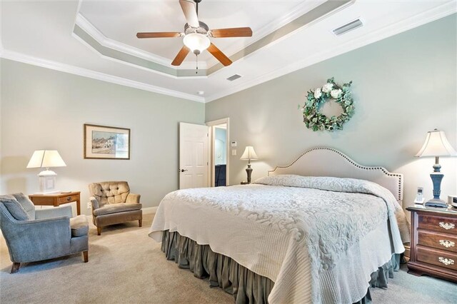 carpeted bedroom featuring ceiling fan, crown molding, and a tray ceiling