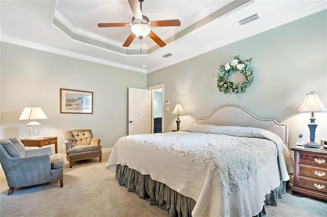 bedroom featuring visible vents, crown molding, carpet, and a tray ceiling