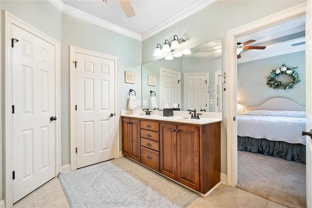 full bath featuring a ceiling fan, ensuite bath, double vanity, a sink, and ornamental molding