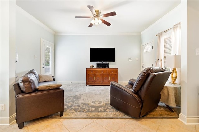 living area featuring light tile patterned floors, a ceiling fan, baseboards, and ornamental molding
