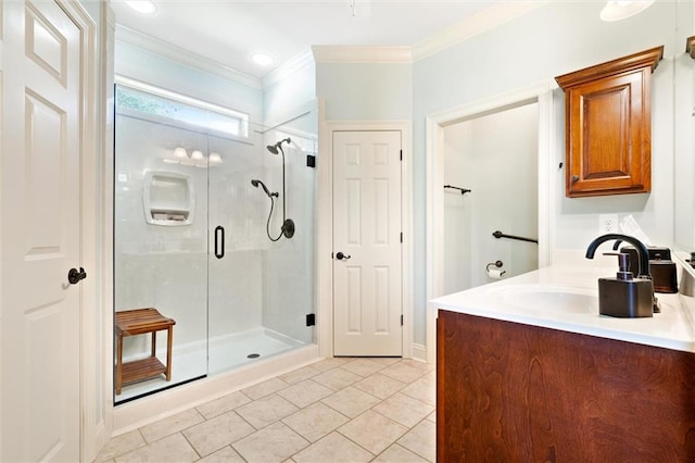 bathroom featuring tile patterned floors, a shower with shower door, vanity, and ornamental molding