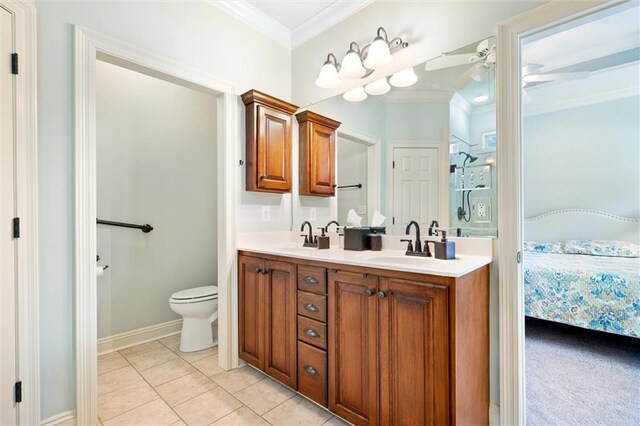 bathroom featuring ceiling fan, crown molding, dual bowl vanity, toilet, and tile patterned flooring