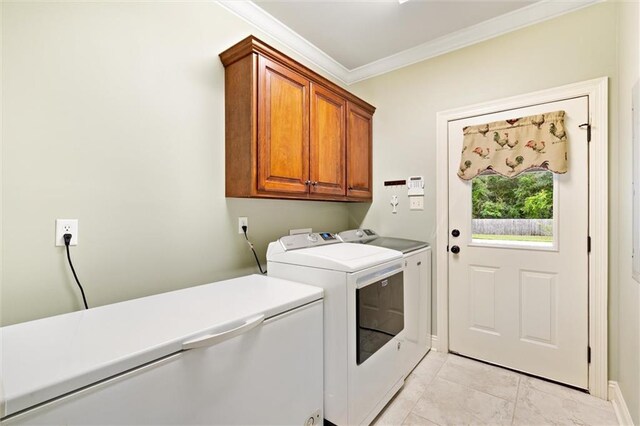 laundry room featuring light tile patterned flooring, washer and dryer, cabinets, and ornamental molding