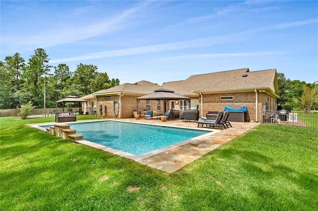 view of swimming pool with a gazebo, a patio, a lawn, and fence