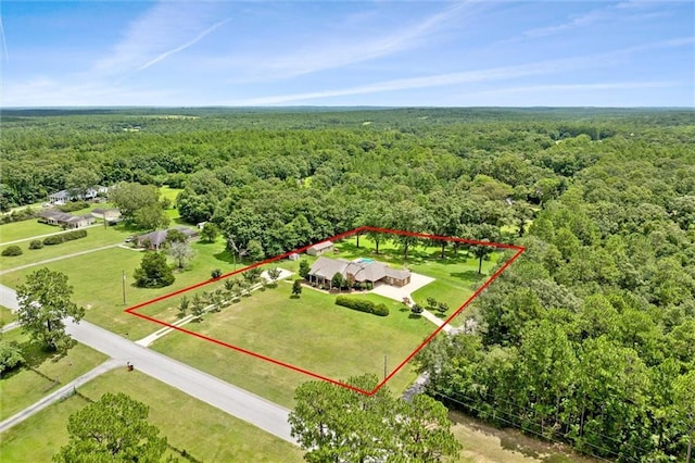 bird's eye view featuring a view of trees and a rural view