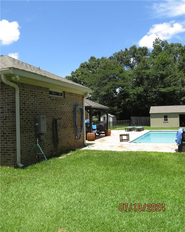 view of swimming pool featuring a patio and a lawn