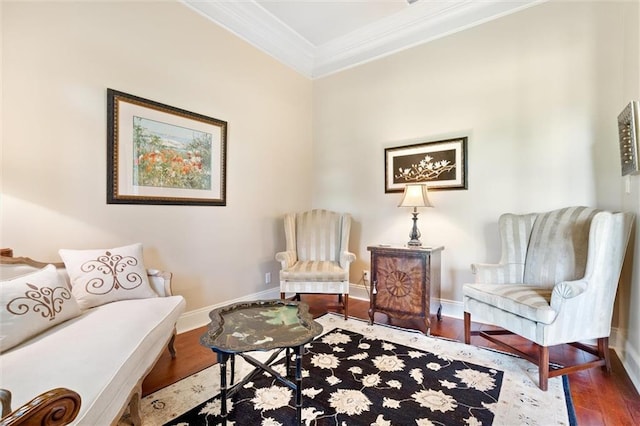 sitting room with crown molding, baseboards, and wood finished floors