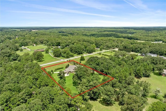 birds eye view of property with a view of trees