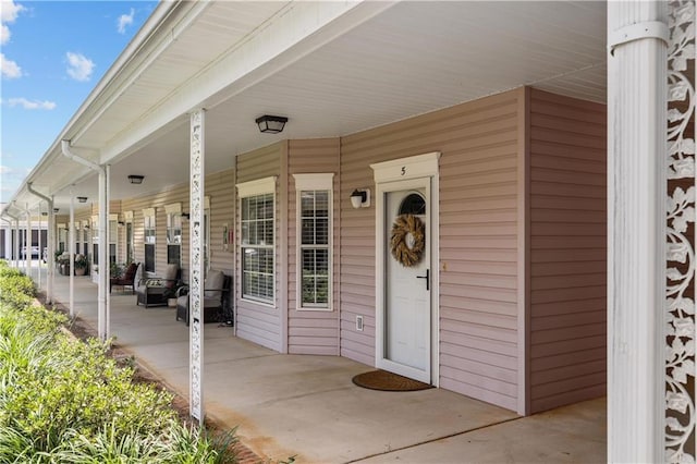 view of exterior entry with covered porch