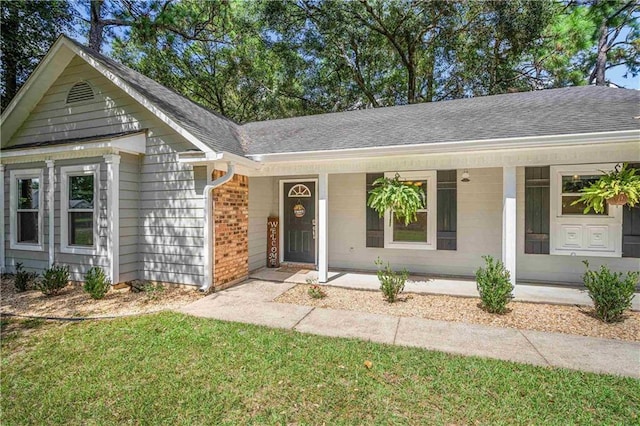 single story home featuring a front yard and covered porch