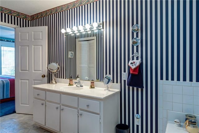 bathroom featuring tile flooring and vanity