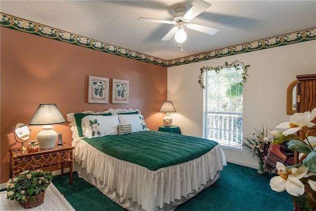 bedroom with ceiling fan, carpet, and a textured ceiling