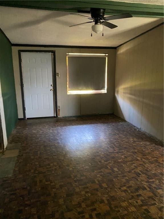 spare room with ornamental molding and ceiling fan