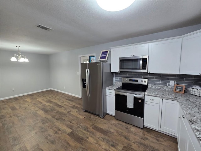 kitchen with white cabinets, a notable chandelier, backsplash, and stainless steel appliances