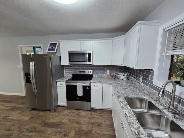 kitchen featuring white cabinetry, sink, dark wood-type flooring, and appliances with stainless steel finishes