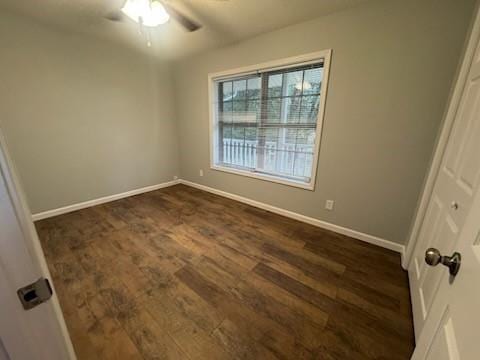 unfurnished room featuring dark hardwood / wood-style floors and ceiling fan