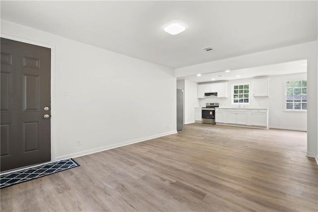 912 David Langan Dr W, Mobile, AL 36608 - unfurnished living room with light wood-type flooring and recessed lighting