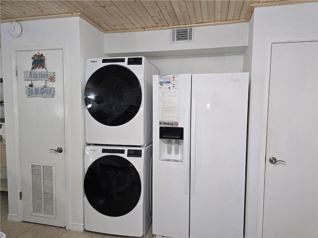 laundry room featuring wood ceiling, light tile patterned floors, and stacked washer / drying machine